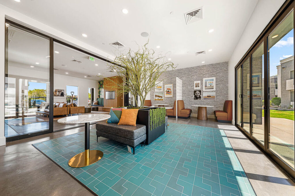 Indoor clubhouse with glass walls and eating areas, sitting areas