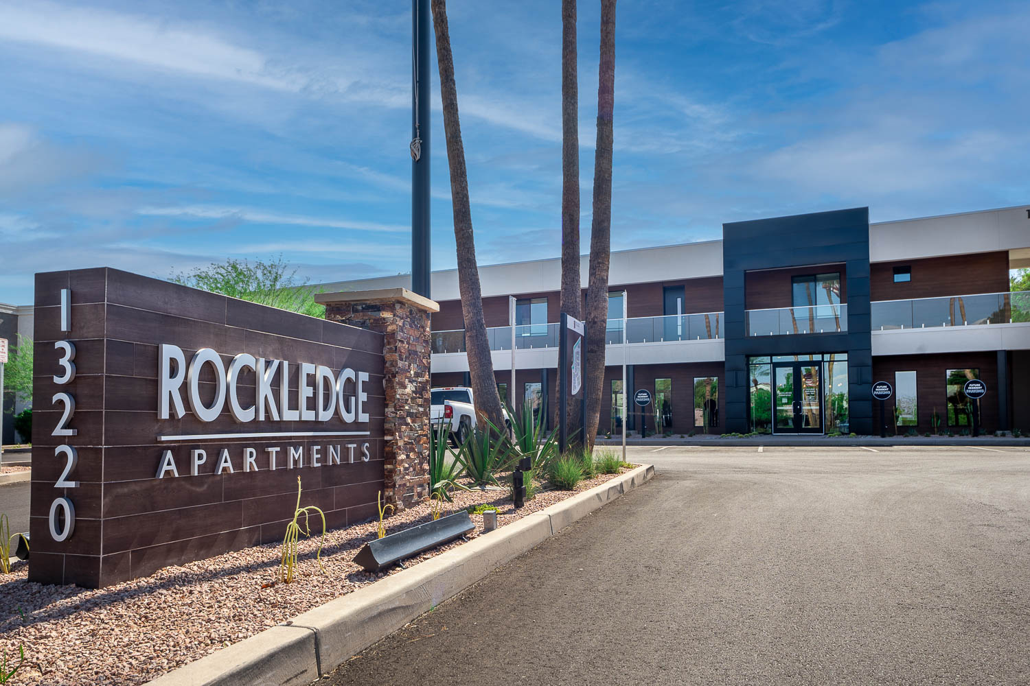 Rockledge Apartment exterior view of front sign and front building as you enter complex